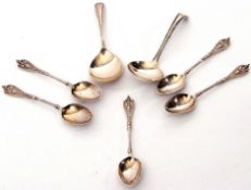 Set of five late Victorian coffee spoons with mask embossed cast handles, foliate engraved backs