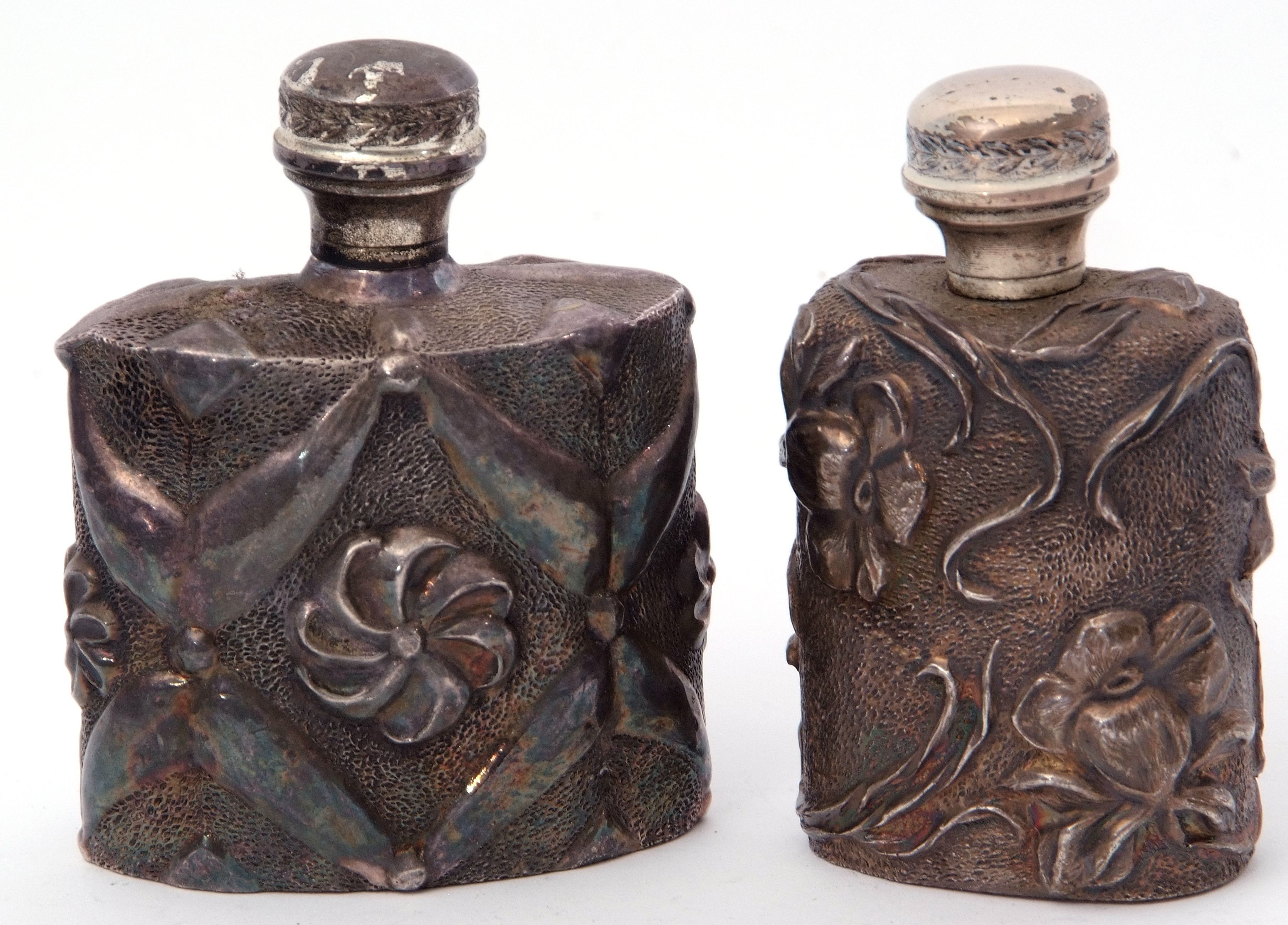 Two late 20th century Art Nouveau style silver plated spirit flasks, heavily chased with floral