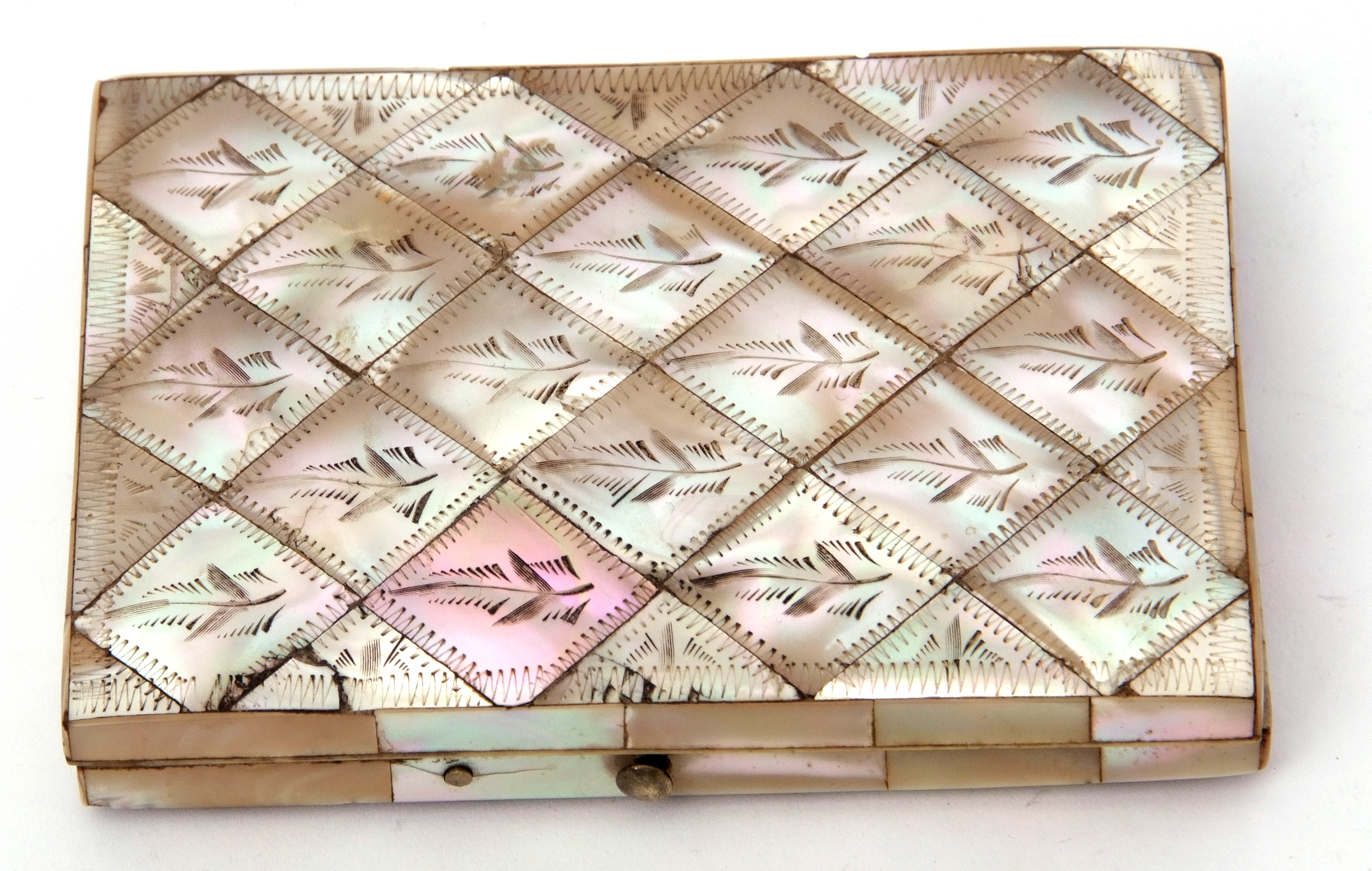 Victorian mother of pearl encased folding card case having foliate engraved diamond shaped panel,