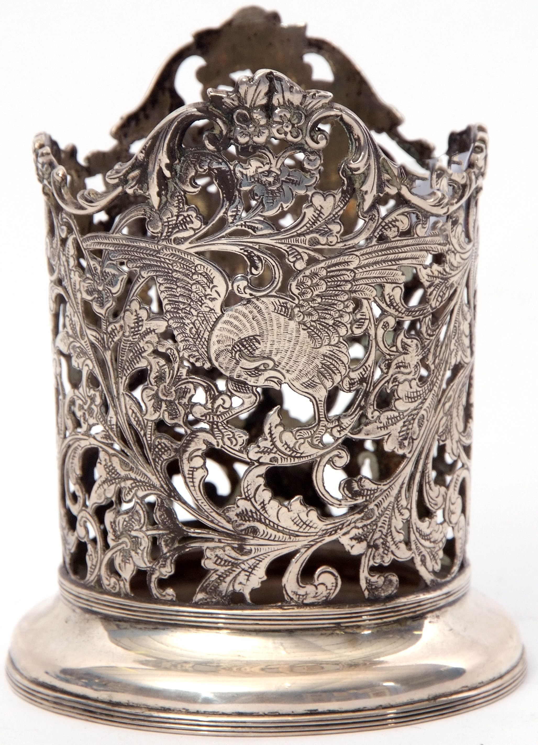 Early 20th century French white metal bottle stand of cylindrical form, well pierced and engraved