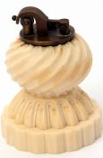 Early 20th century carved ivory table lighter of fluted and waisted circular form with brass lighter
