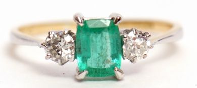 Emerald and diamond three stone ring, the rectangular shaped centre emerald 6 x 4mm, flanked by 2