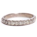 Modern precious metal diamond half eternity ring, featuring 13 single cut diamonds, stamped 10K,