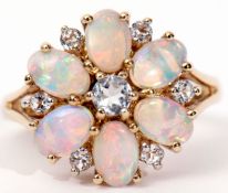 A 9ct gold opalescent ring, a flowerhead design highlighted throughout with small paste stones, size