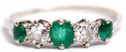 Precious metal emerald and diamond five-stone ring, alternate set with 3 graduated emeralds and 2