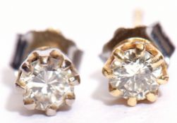 Pair of diamond stud earrings, the brilliant cut diamonds raised in coronet settings, having post