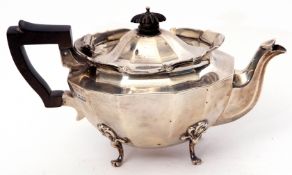 Edward VII bachelor's tea pot of panelled oval form, having scrolled apron and ebonised handle and