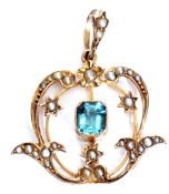 9ct stamped open work pendant centring a bezelled and millegrain set blue stone in a seed pearl