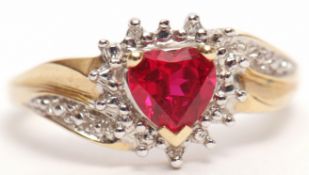 Modern 9ct gold diamond and red stone ring, the heart shaped red stone within a surround of small