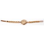 Ladies 9ct gold cased Revue wrist watch with gold hands to a cream coloured dial with raised gold