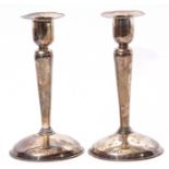 Pair of early Elizabeth II solid candlesticks with hollow domed bases, tapering baluster stems and