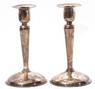 Pair of early Elizabeth II solid candlesticks with hollow domed bases, tapering baluster stems and