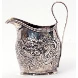 George III helmet cream jug, later embossed with floral and foliate design, reeded looped handle,