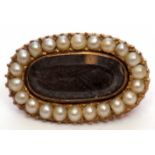 Victorian gold and seed pearl mourning brooch, the oval glazed panel with plaited hair beneath,