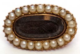 Victorian gold and seed pearl mourning brooch, the oval glazed panel with plaited hair beneath,