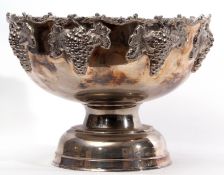 Large circular silver plated punch bowl of pedestal form, the border embossed with C-scrolls and