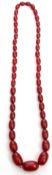 Vintage cherry amber bead necklace, a single row of oblong graduated beads, 1cm to 2.5cm, 30cm