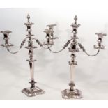 Pair of silver plated two-branch candelabra moulded throughout with C-scrolls, berries and foliage