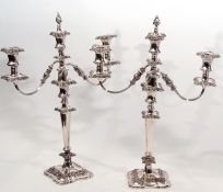 Pair of silver plated two-branch candelabra moulded throughout with C-scrolls, berries and foliage