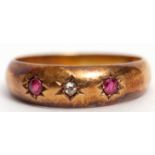 Early 20th century 18ct gold diamond and ruby ring featuring a centre diamond between 2 circular cut