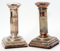 Pair of late Victorian silver encased dressing table candlesticks on loaded stepped bases with