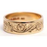 9ct gold wedding band engraved and chased with floral and foliate design, 3.6gms, size L/M