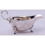 George V sauce boat in early Georgian style, having card cut rim, flying scrolled handle and