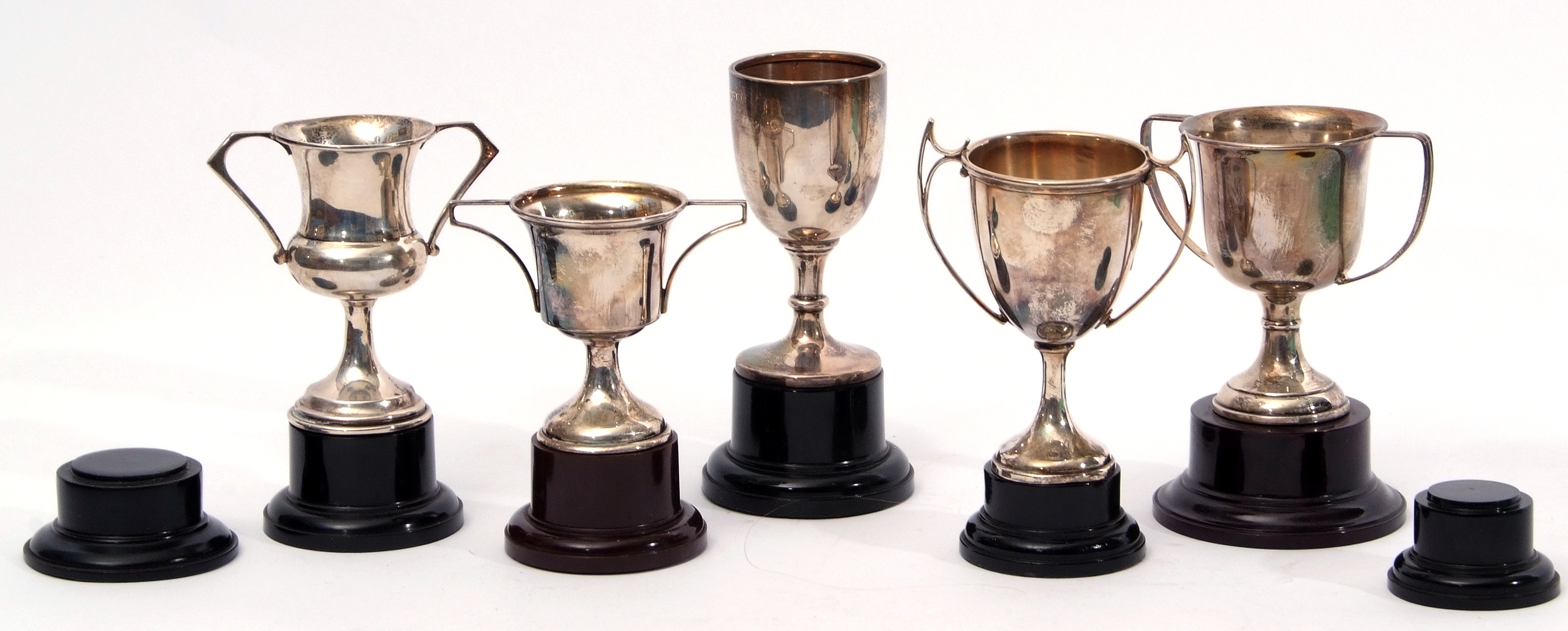 Mixed Lot: comprising five hallmarked silver trophy cups, all with twin handles, together with seven