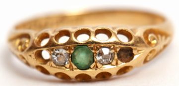 Edwardian 18ct gold emerald and diamond ring, boat shaped, centring a circular cut emerald flanked
