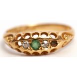 Edwardian 18ct gold emerald and diamond ring, boat shaped, centring a circular cut emerald flanked