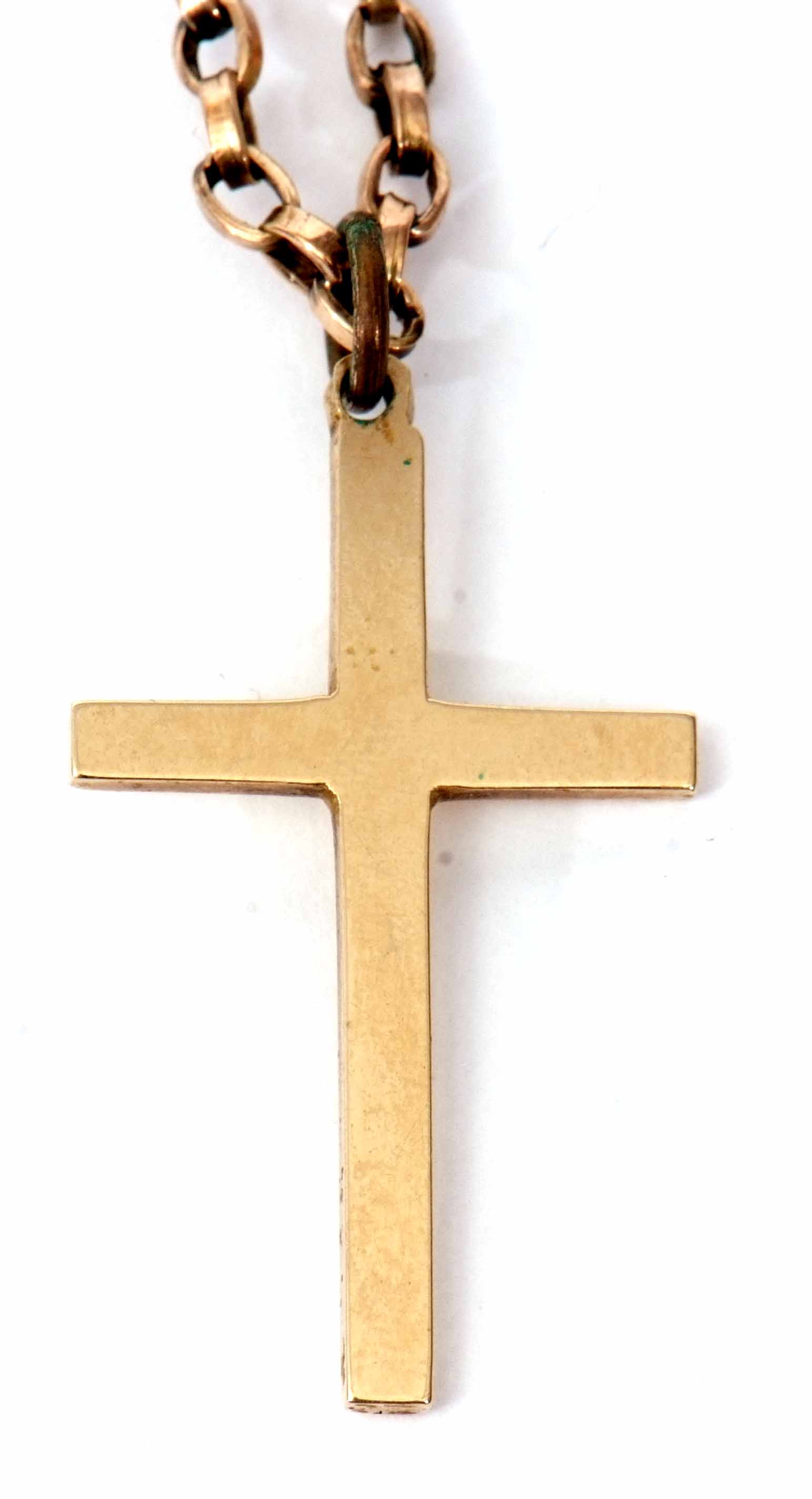 A 9ct gold plain polished cross suspended from a yellow metal oval link chain (unmarked), gross