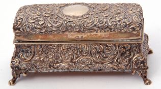 Edwardian silver dressing table ring box of casket form, the bombe shaped base supported on four