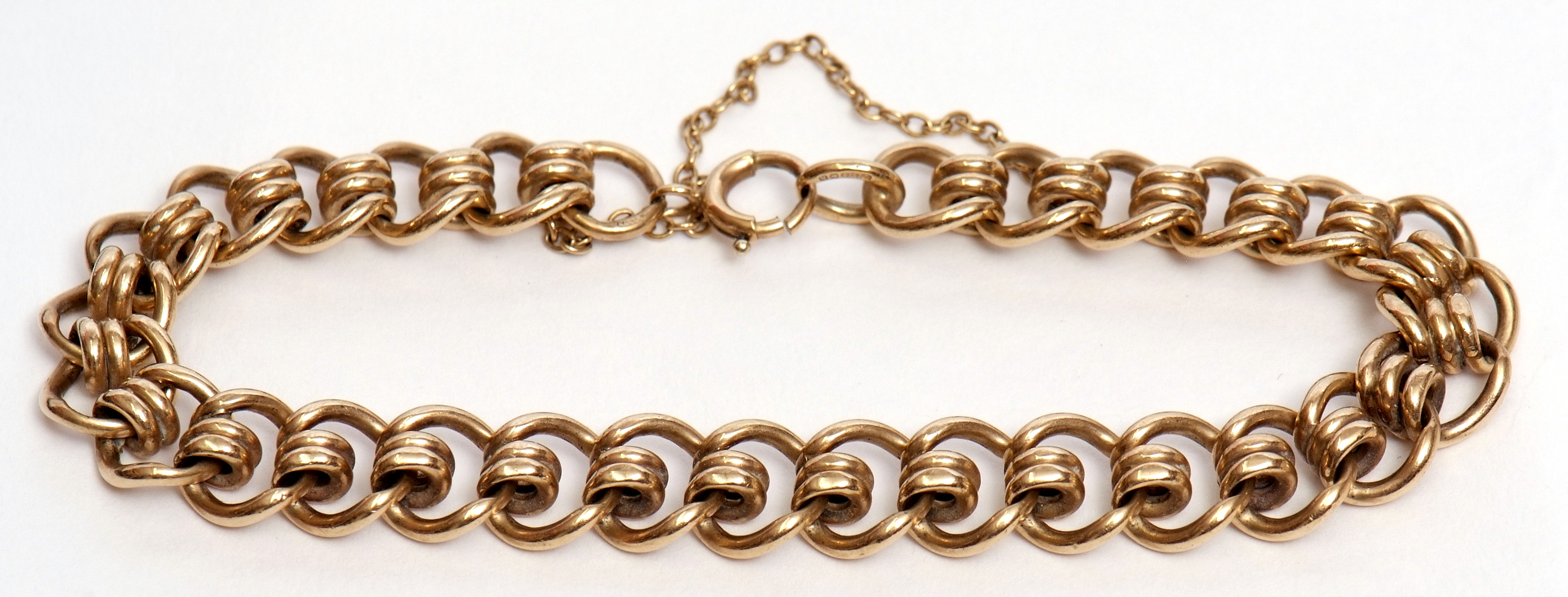 9ct gold curb and coil link bracelet, safety chain fitting, hallmarked Birmingham 1982, 27.8gms