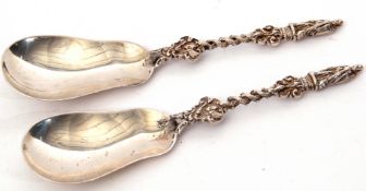 Interesting pair of Edwardian fruit serving spoons having plain pear shaped bowls, the cast stems
