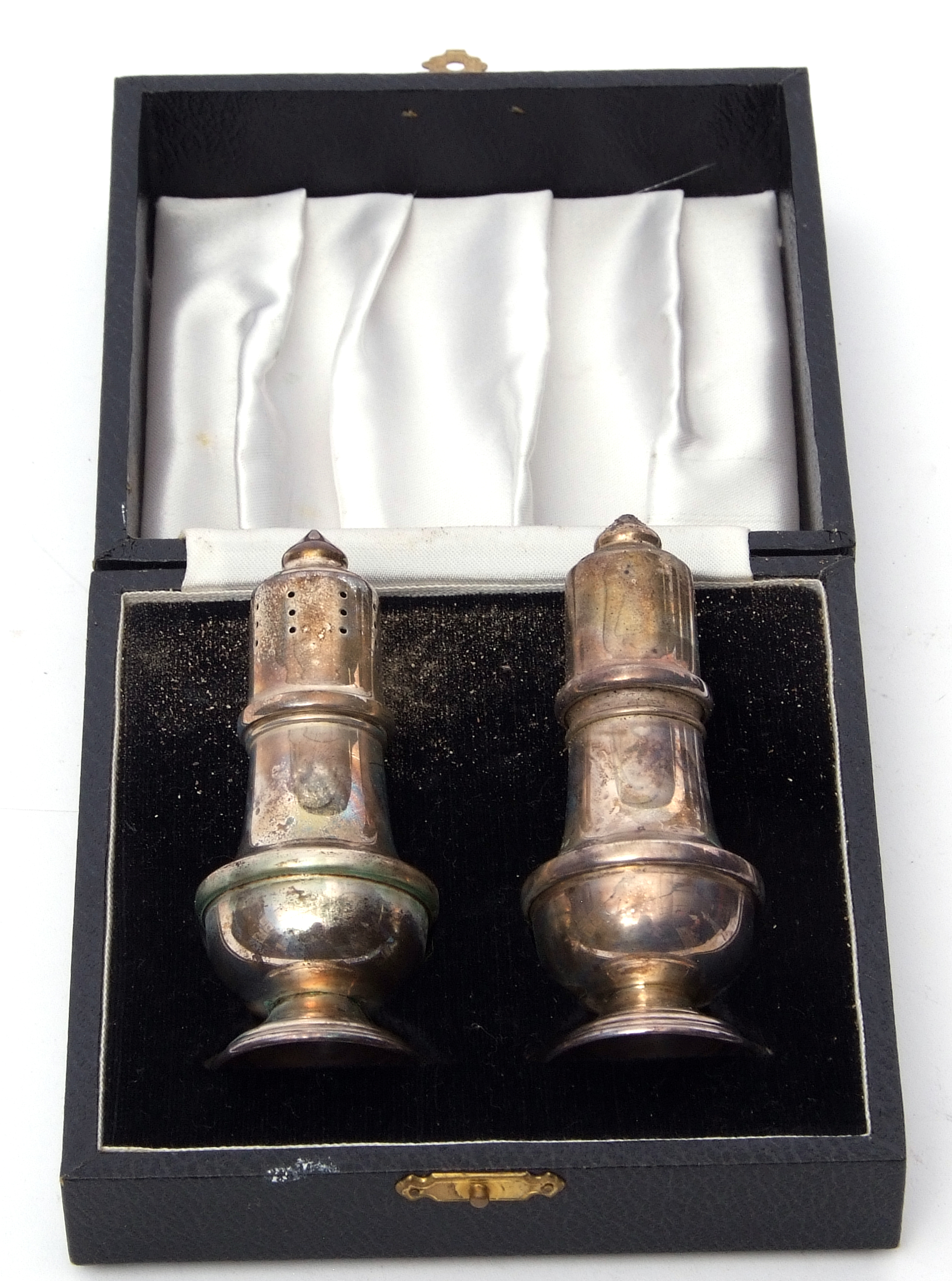 Cased silver and pepper and salt each of baluster form on spreading foot base, Birmingham 1978,