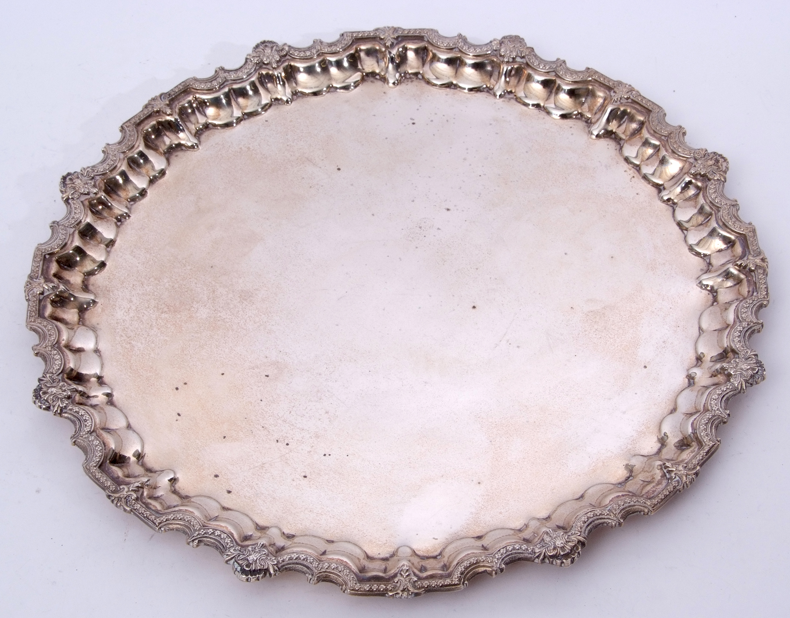 Middle Eastern white metal large salver of shaped circular form with applied shell and scroll