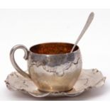 Continental white metal cup and saucer with spot hammered and polished finish, the saucer with