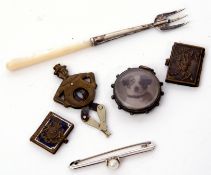 Mixed Lot: silver and mother of pearl handled preserve fork, a double sided photo locket in a silver