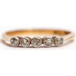 Five stone diamond ring featuring 5 small diamonds, individually bezel set, stamped 18ct and Pt,