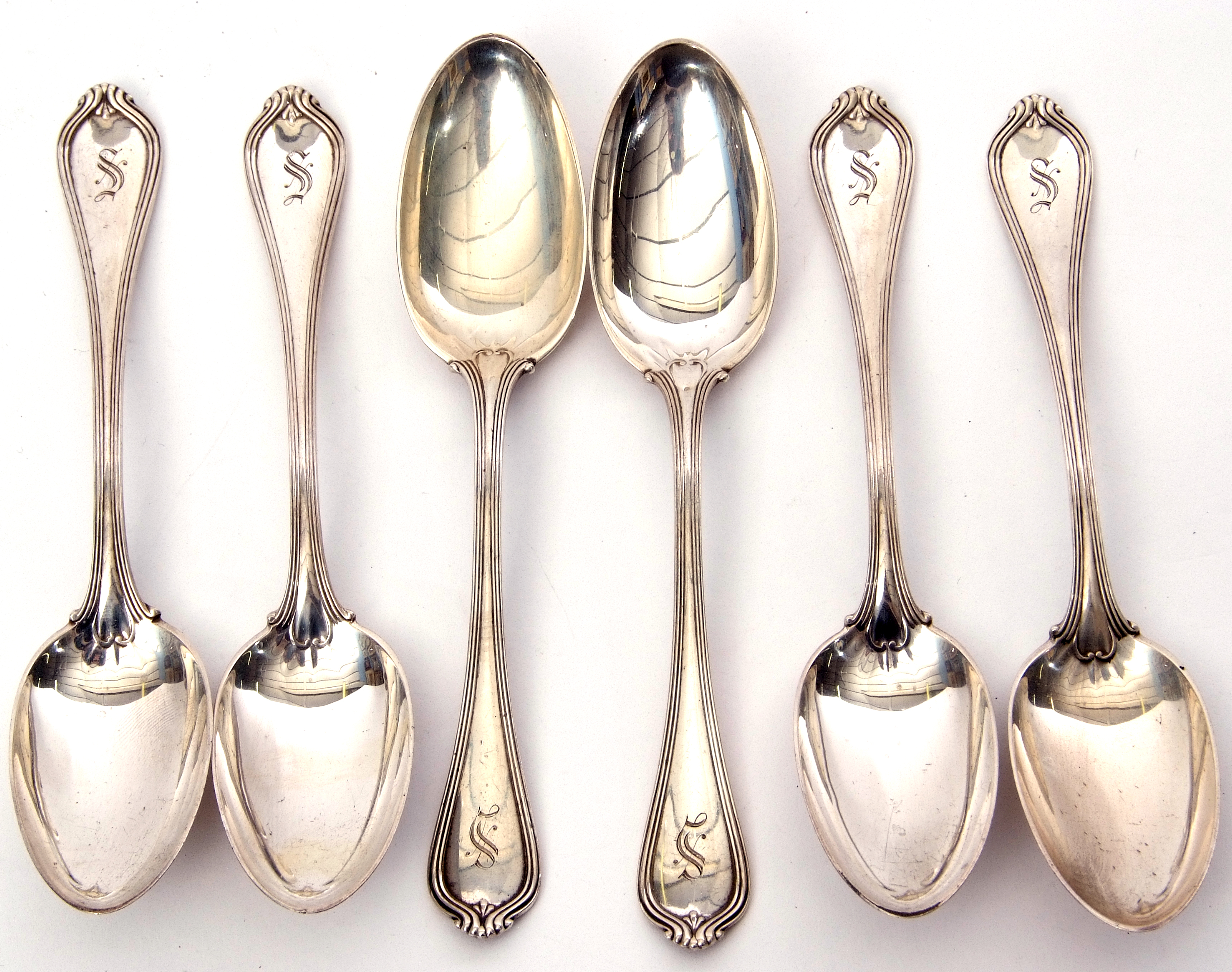 Set of six early 20th century white metal large tea spoons with pointed ends, each engraved with