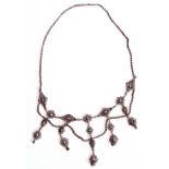 Vintage white metal filigree fringe necklace with intricate filigree lozenges and flower heads,