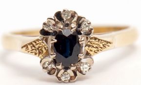 18ct gold sapphire and diamond cluster ring, the dark oval faceted sapphire set between six small