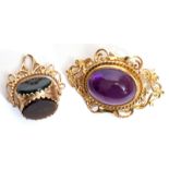 Mixed Lot: 9ct gold and amethyst brooch, a large oval amethyst cabochon in an ornate rope and scroll