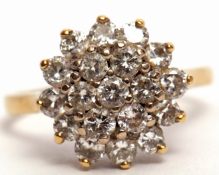 Diamond cluster ring, a two-tier design with 7 diamonds in a cluster raised within a 12-diamond