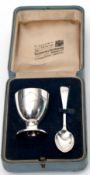 Cased silver egg cup and spoon set, both engraved with "TONY", silk lined interior, stamped "By