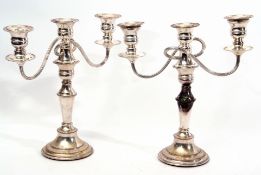 Pair of silver plated two-branch candelabra with plain balustered and beaded stems, terminating in