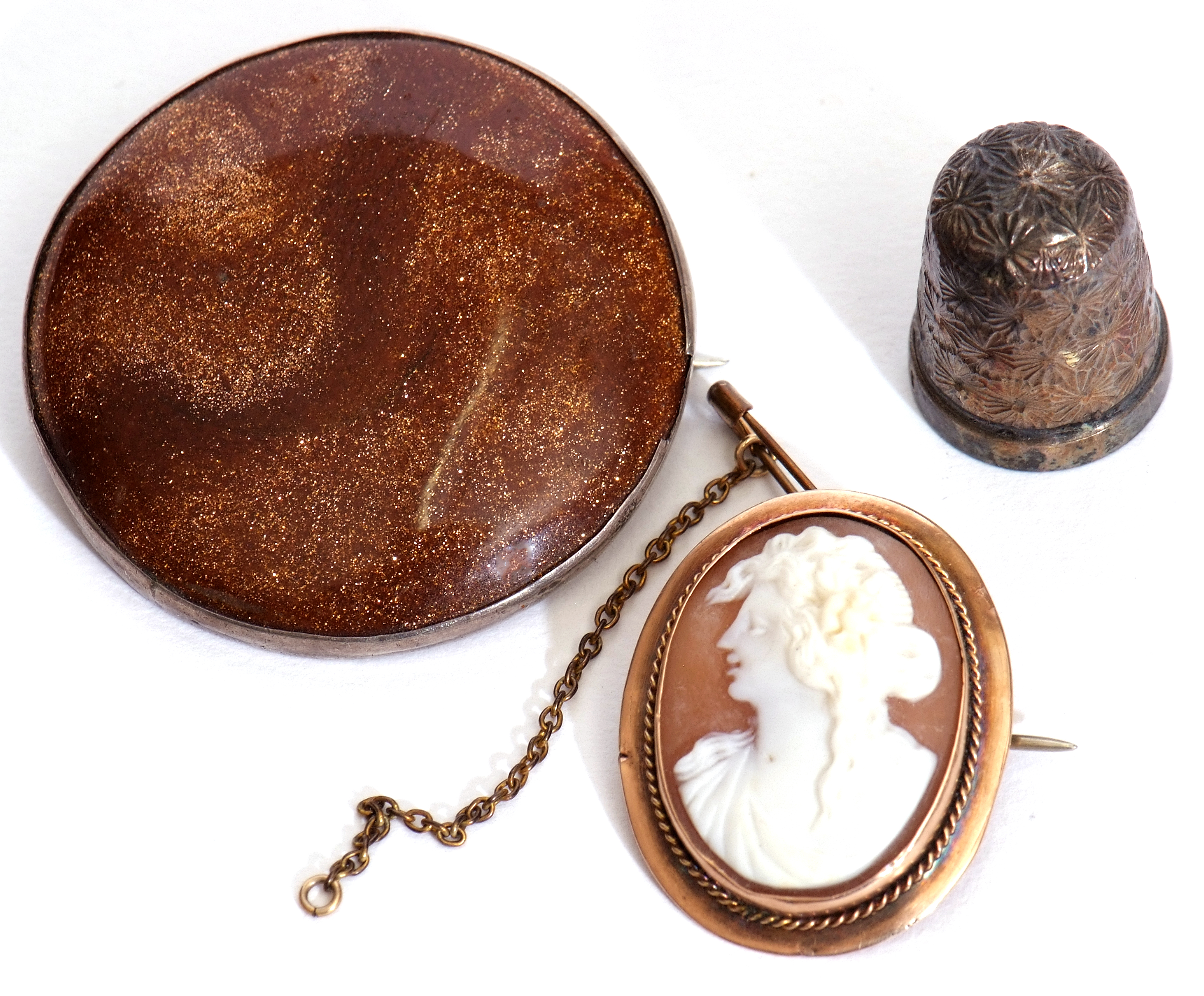 Mixed Lot: large circular shaped sandstone brooch in a white metal mount, a carved shell cameo