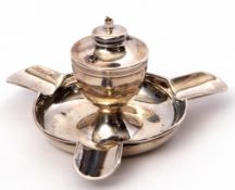 George V table lighter/ashtray of circular form with three lugs and central vase shaped burner,