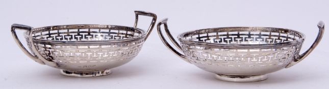 Pair of George V two-handled circular bon-bon dishes of good gauge, the sides pierced with geometric