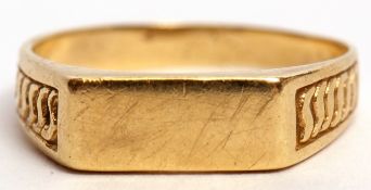 Mid-grade yellow metal ring, the rectangular shaped polished panel raised between engraved